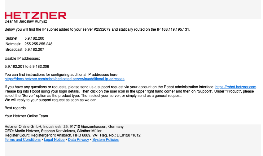 Kobieta w medycznym ubraniu trzymająca dokumentację i uśmiechająca się.