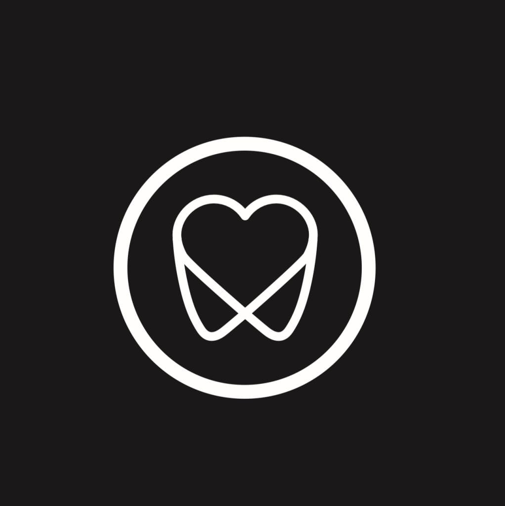 Symbol zęba w kształcie serca w okręgu na czarnym tle