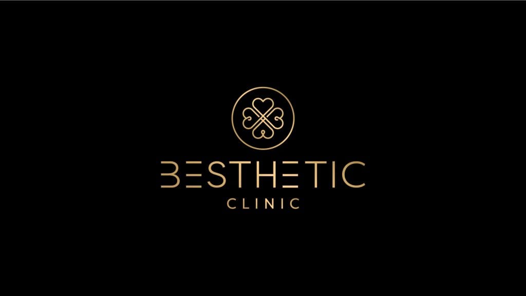 Logo kliniki medycznej Besthetic w eleganckim złotym kolorze na czarnym tle